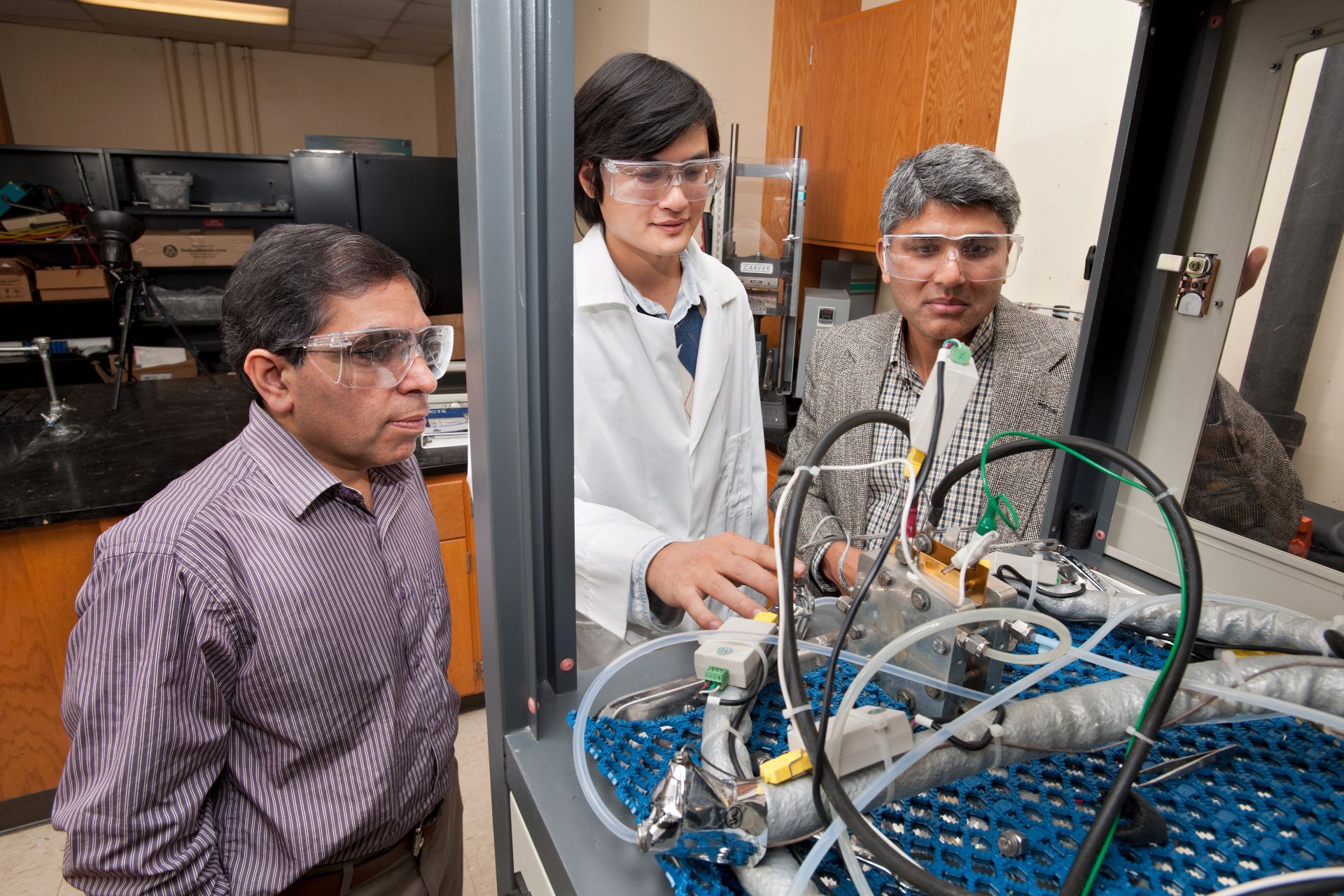 researchers near lab equipment